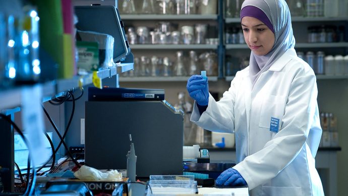 Student wearing a hijab working in a lab